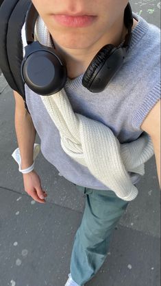 a young man wearing headphones on his neck