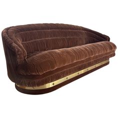 a large brown couch sitting on top of a wooden table