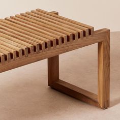 a wooden bench sitting on top of a white floor