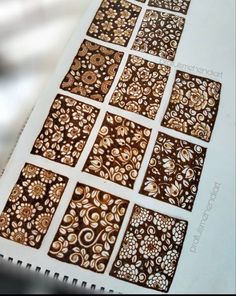 an open book with brown and white designs on it