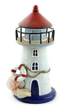 a ceramic lighthouse with a life preserver on top