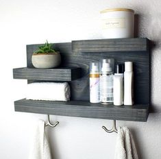 two wooden shelves holding different types of personal care items and a potted succulent