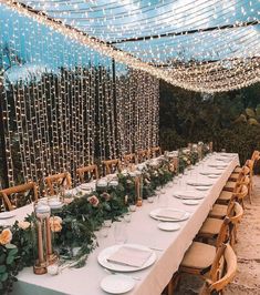 a long table is set with plates and place settings