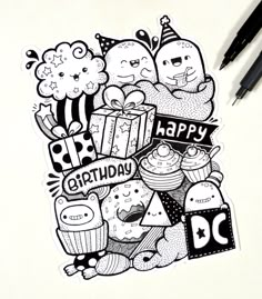 a black and white drawing of happy birthday stickers on a piece of paper next to some markers