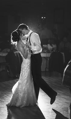 a bride and groom share their first dance