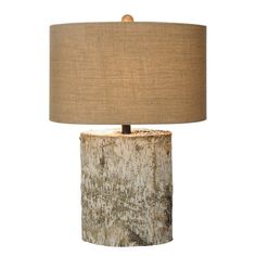 a lamp that is made out of wood and has a brown shade on top of it