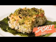 sushi bake on a white plate topped with green sauce and garnish