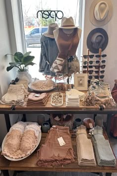 an assortment of clothing and hats on display