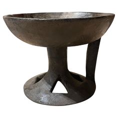 a large metal bowl sitting on top of a table