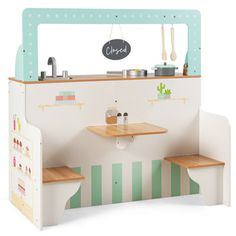 a small children's play kitchen with wooden shelves