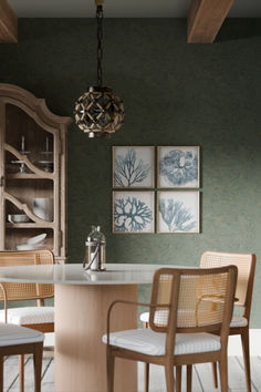 a dining room table with chairs and pictures hanging on the wall behind it in front of a china cabinet