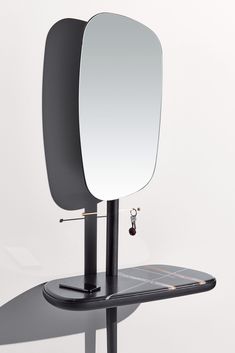 a mirror sitting on top of a metal stand