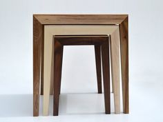 three wooden tables stacked on top of each other