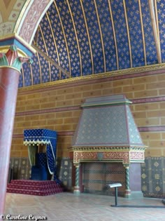 an ornately decorated room with blue and gold decor on the walls, pillars and ceiling