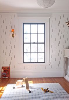 an empty room with white walls and wood flooring is shown in the foreground