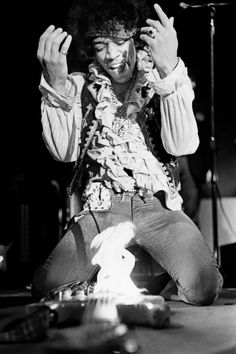 a man sitting in front of a microphone on top of a stage