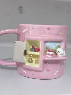 a pink coffee mug with an oven on it