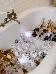 a bath tub filled with lots of bottles and ice