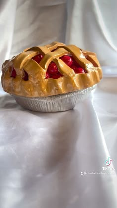 a pie sitting on top of a white table cloth