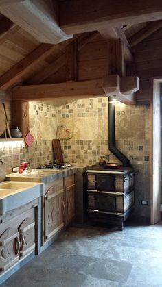 a kitchen with an oven, sink and stove in the middle of it's walls