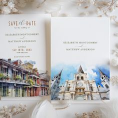 two wedding cards on top of each other with watercolor buildings and flowers in the background