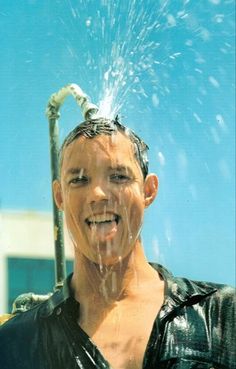 a man is sprinkling water on his head