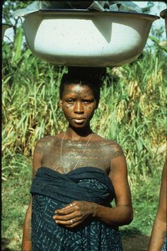 the woman is carrying something on her head