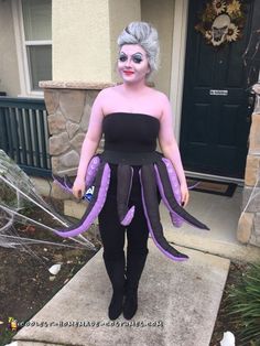 a woman dressed up as an octopus in front of a house