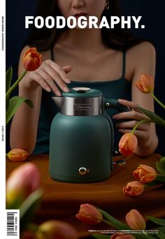 a woman sitting at a table with a teapot and flowers in front of her