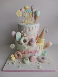 a birthday cake with donuts, doughnuts and other sweets on the top