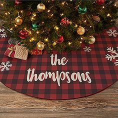 a red and black christmas tree skirt with snowflakes on it that says, the thompsons