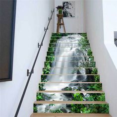 this is an image of a stair case with waterfall and trees on the bottom floor