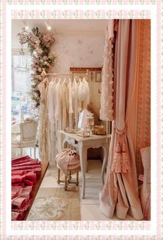 a room filled with lots of white dresses and pink curtains on the windows sill