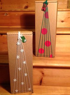 two boxes with christmas decorations on them sitting on some steps