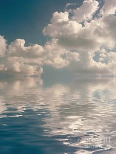 the sky is filled with clouds and reflecting on the water's surface as if it were floating in the ocean