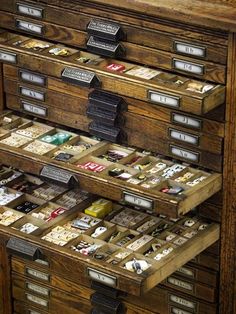 an old wooden filing cabinet filled with lots of cards