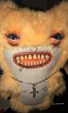 a stuffed animal with teeth and chains on it's face