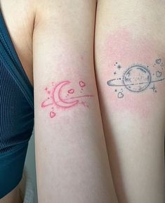 two women with tattoos on their arms and one has a saturn tattoo on her arm