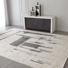 a white rug with black and grey designs on it