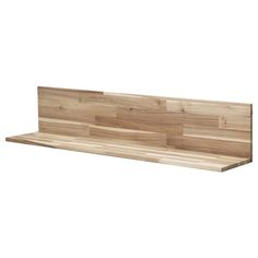 a wooden shelf sitting on top of a white wall