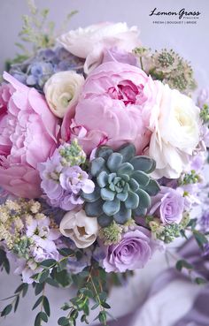 a bouquet of pink and white flowers with succulents on the bottom is shown