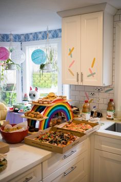 a kitchen filled with lots of food on top of a counter