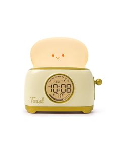 the toast alarm clock is yellow and has a face on it's front end