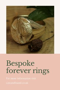 a gold ring with the words bespoke forever rings on it and a rose