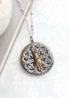 "Rabbit are symbols of abundance, comfort, and vulnerability. This locket is a beautiful vintage style necklace with a rabbit focal set on antiqued silver lace filigree...  Inspired by vintage style and times gone by... this is a large round locket necklace with layers of antiqued silver brass lace filigree layers on an antiqued brass locket! On the center of the locket is a raised antiqued brass rabbit. This mixed metal locket is beautifully detailed! Details:  ~ Locket measures approx. 1.75\" Hare Animal, Round Locket Necklace, Unique Locket, Purple Pendant Necklace, Rabbit Earrings, Woodland Jewelry, Vintage Style Necklace, Rabbit Pendant, Picture Locket