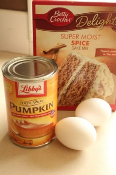 two eggs and a can of cake mix sitting on a counter next to a package of deli lights