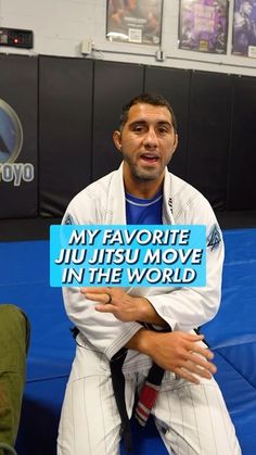 a man holding a sign that says my favorite jiu jitsu move in the world