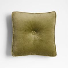 an olive green pillow with a button on the front and back side, against a white background