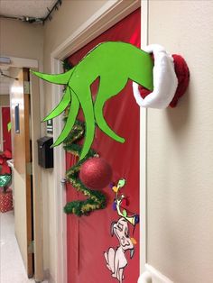 the grinch door is decorated with christmas decorations and stockings hanging from it's hooks