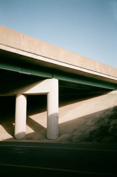 an overpass with two white pillars on the side